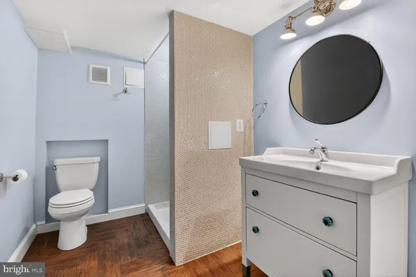 a bathroom with a toilet sink and mirror