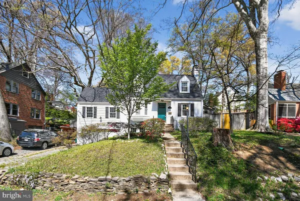 a front view of a residential apartment building with a yard