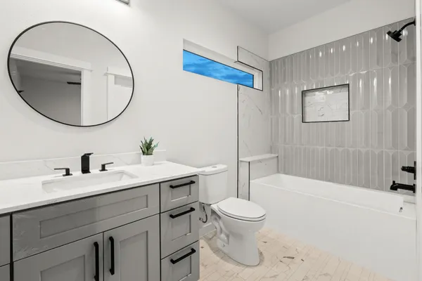 a bathroom with a sink a toilet and a mirror