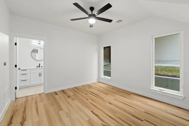 wooden floor in an empty room with a window