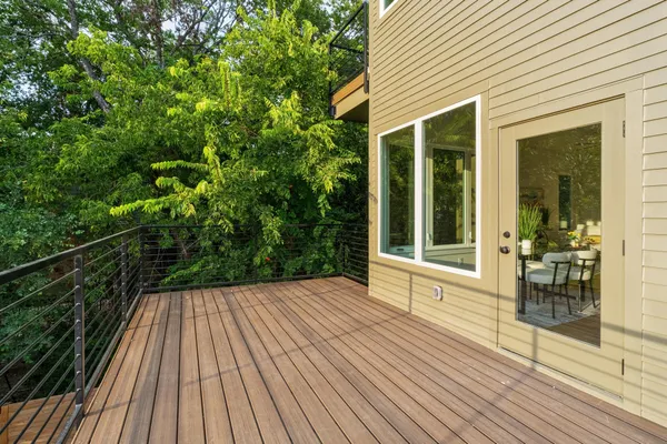 a view of balcony with floor to ceiling windows with wooden floor