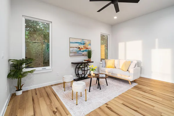a living room with furniture and a potted plant