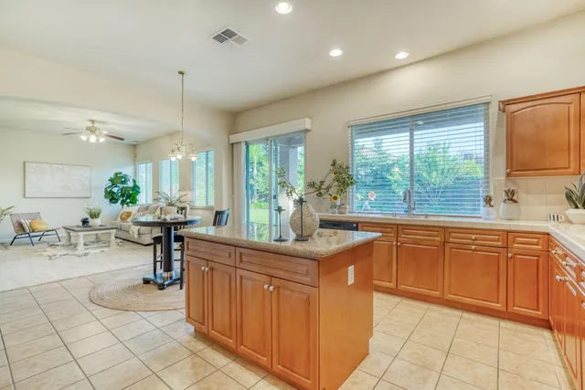 a kitchen with stainless steel appliances granite countertop a sink stove and cabinets
