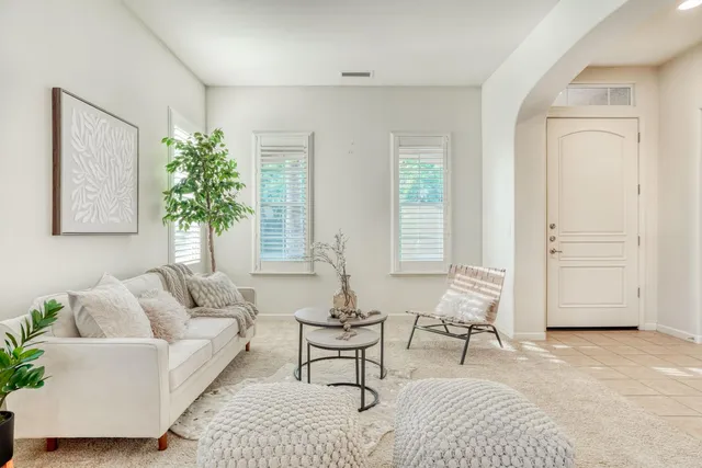 a living room with furniture and a large window