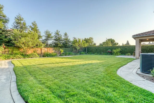 a spacious bathroom with a double vanity sink a large mirror and a bathtub with shower