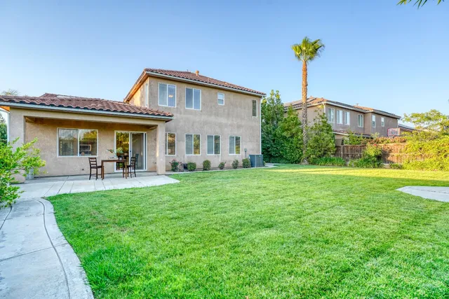 a spacious bedroom with a bed and a chandelier
