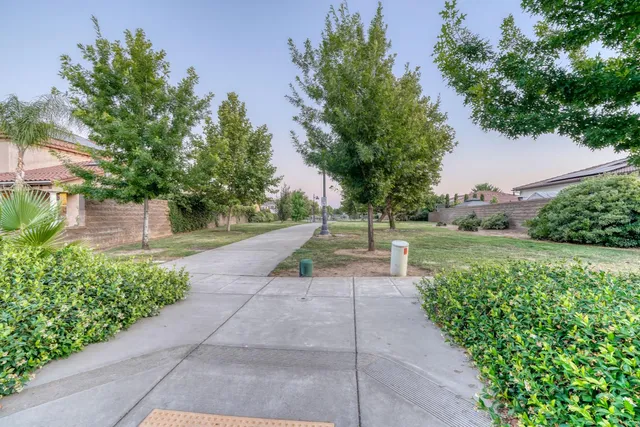 an empty room with a window and a ceiling fan