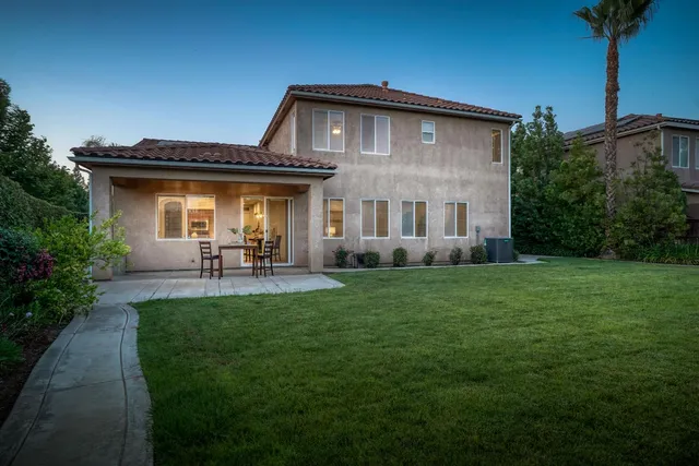 an empty room with a ceiling fan and carpet