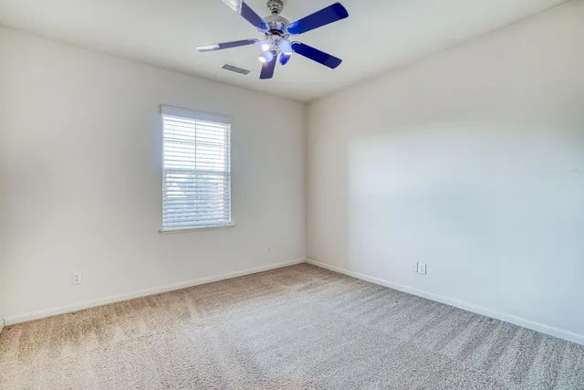 a front view of a house with a garden and plants