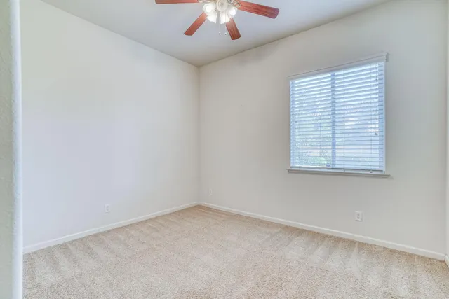 a front view of a house with a garden and plants