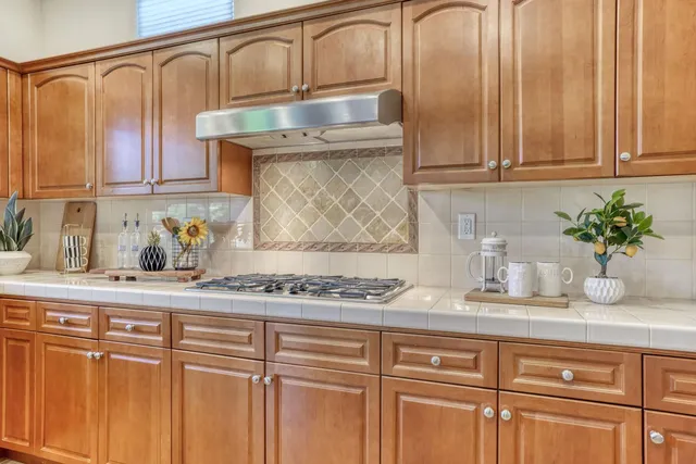 a kitchen with stainless steel appliances granite countertop a sink a cabinets and a granite counter tops
