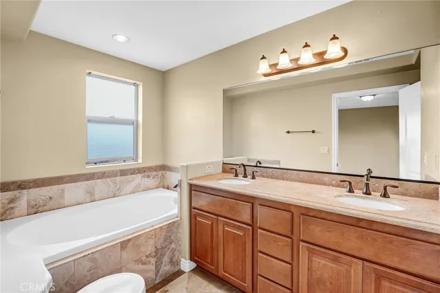 a bathroom with a granite countertop sink a mirror and a shower