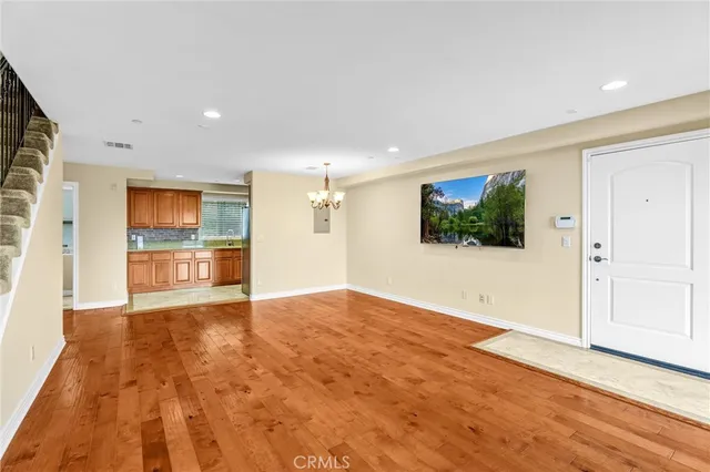 a view of a livingroom with a ceiling fan window and hardwood floor