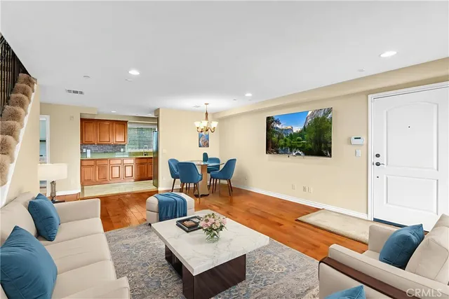 a living room with fireplace furniture and a chandelier