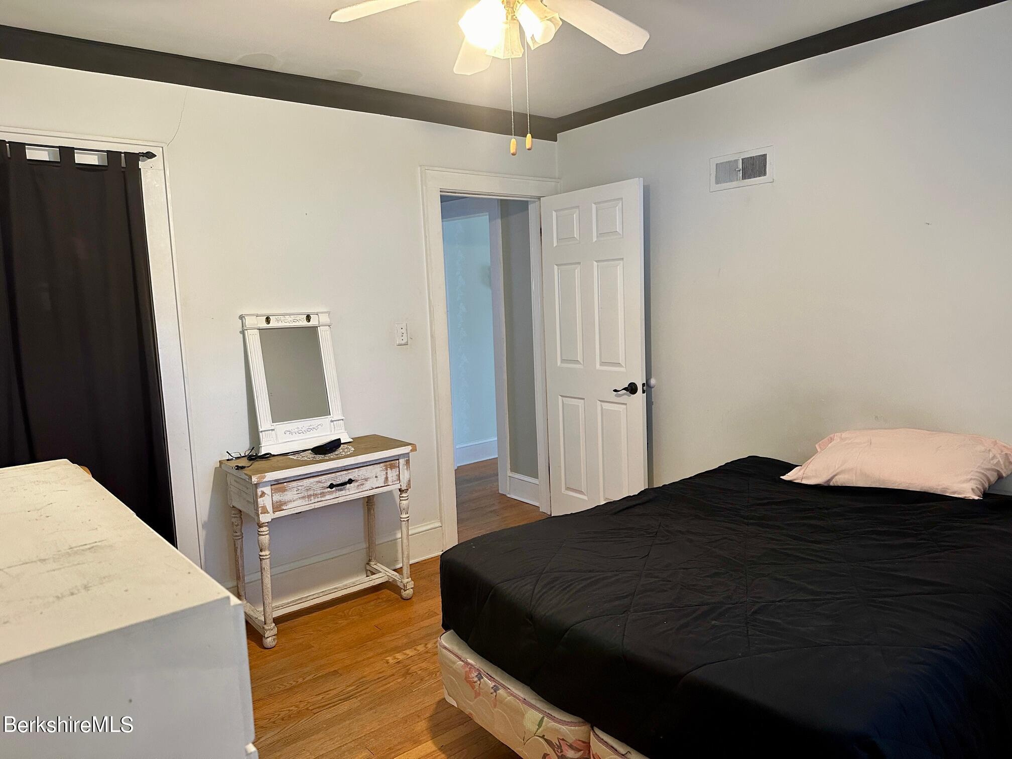 80 Preston Avenue Pittsfield, MA 01201 - Photo 19 of 33 a bedroom with a bed and a chandelier