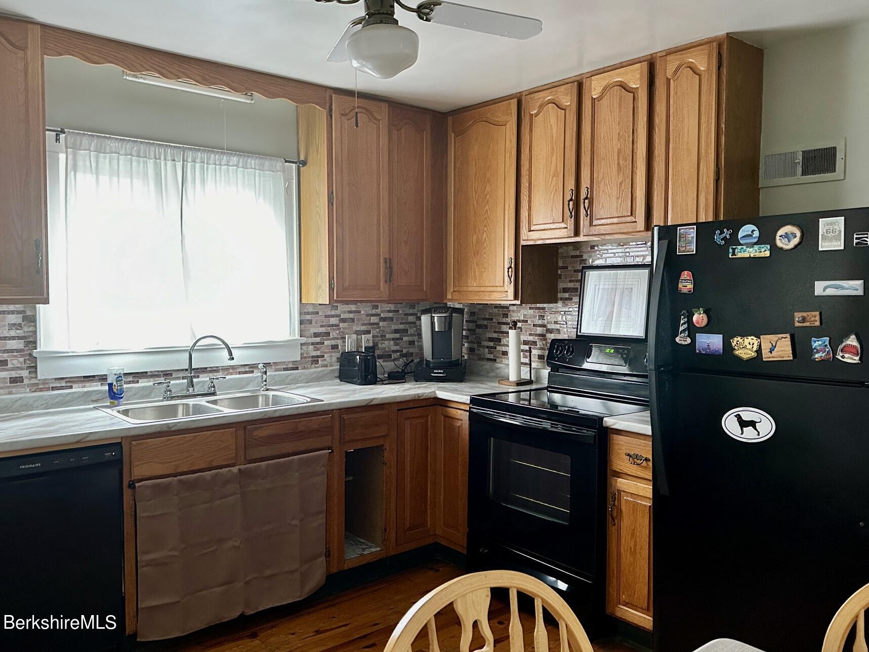80 Preston Avenue Pittsfield, MA 01201 - Photo 2 of 33 a kitchen with stainless steel appliances granite countertop a sink a stove cabinets and a window