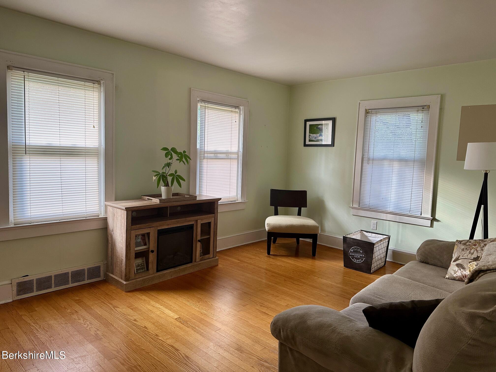 80 Preston Avenue Pittsfield, MA 01201 - Photo 4 of 33 a living room with furniture windows and a fireplace