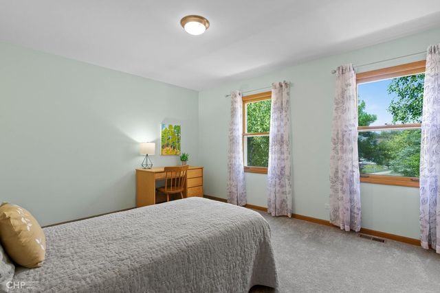 a bedroom with a bed and cabinets