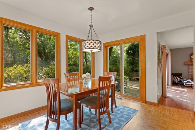 a dining room with furniture window and wooden floor