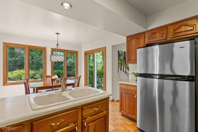 a kitchen with a refrigerator a sink and cabinets