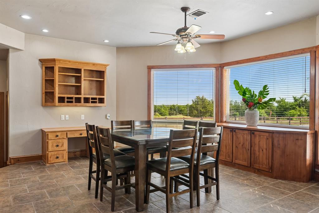 2085 Switzer Road Sanger, TX 76266 - Photo 8 of 39 Spacious room featuring large bay windows, built-in wooden cabinetry, recessed lighting, and a ceiling fan