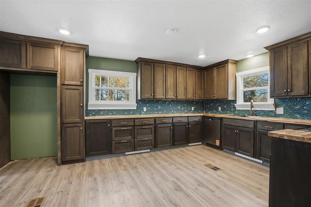 3148 Medlin Road East Mountain, TX 75645 - Photo 13 of 36 a kitchen with stainless steel appliances granite countertop a refrigerator sink and cabinets