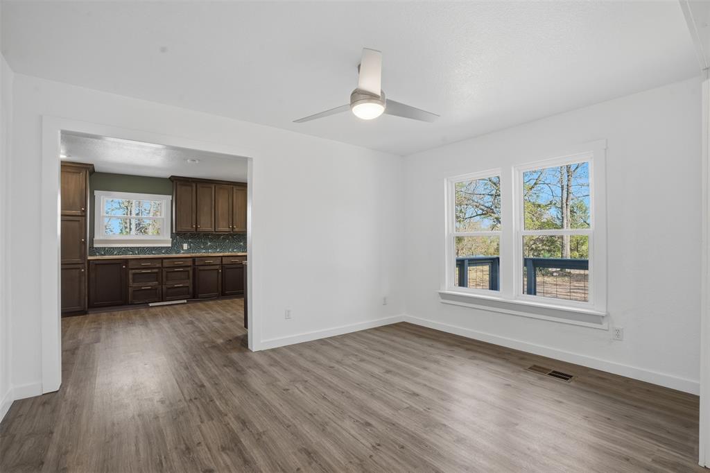 3148 Medlin Road East Mountain, TX 75645 - Photo 15 of 36 a view of an empty room with a window and wooden floor