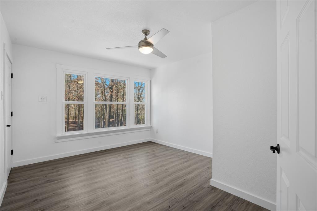 3148 Medlin Road East Mountain, TX 75645 - Photo 16 of 36 a view of an empty room with wooden floor and a window