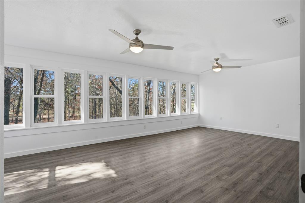 3148 Medlin Road East Mountain, TX 75645 - Photo 18 of 36 a view of an empty room with wooden floor and a window