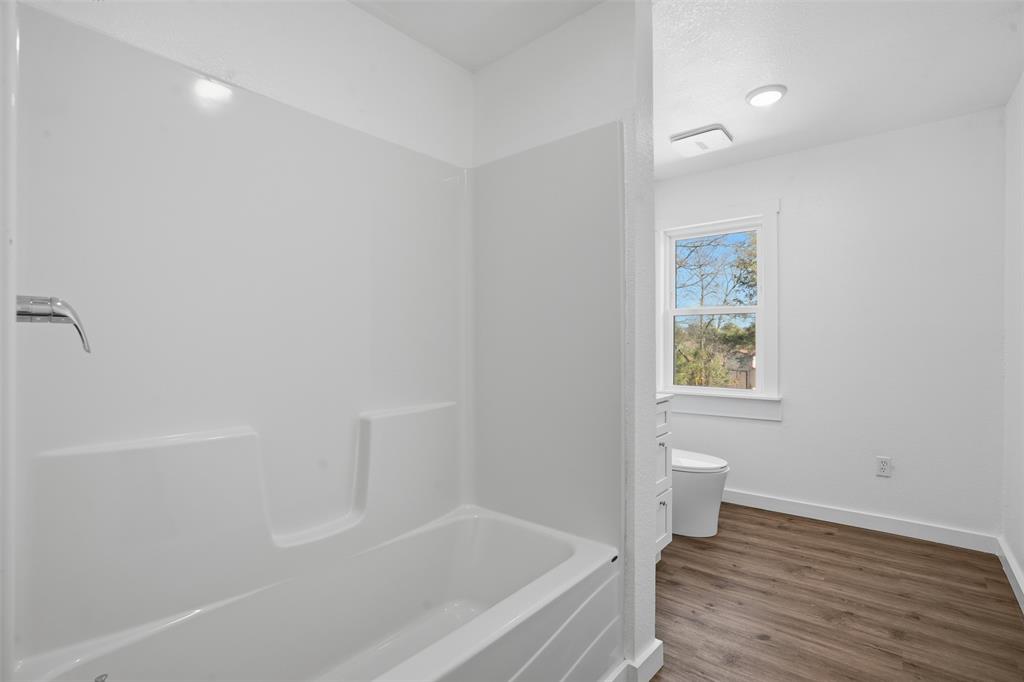 3148 Medlin Road East Mountain, TX 75645 - Photo 21 of 36 a bathroom with a bathtub and toilet