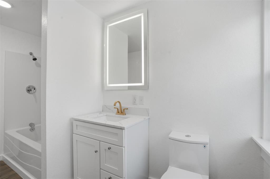 3148 Medlin Road East Mountain, TX 75645 - Photo 22 of 36 a bathroom with a sink a toilet and shower