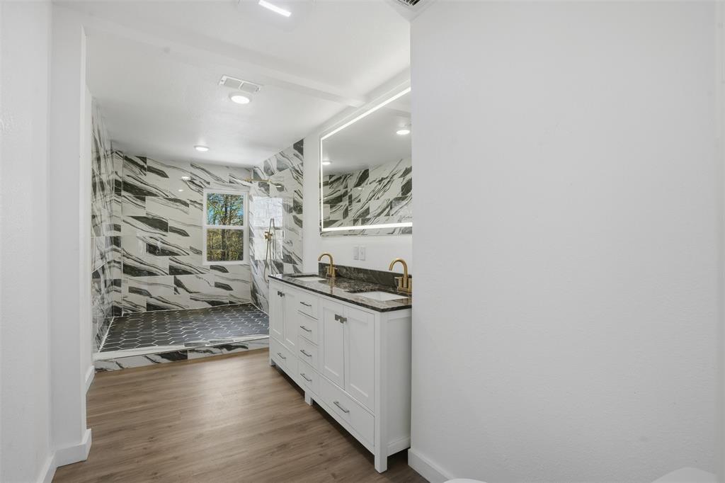 3148 Medlin Road East Mountain, TX 75645 - Photo 24 of 36 a kitchen with granite countertop a stove and cabinets