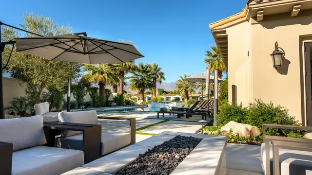 a view of a house with swimming pool and sitting area