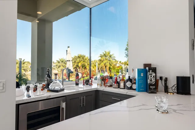 a bedroom with a bed and large window