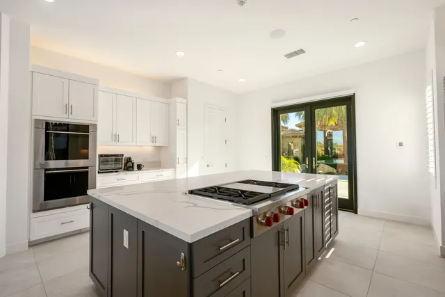 a bedroom with a large bed and a large window