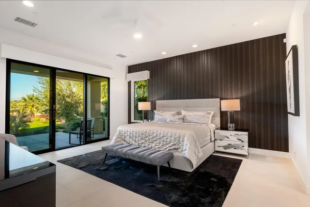 a bathroom with a white tub a sink and a large mirror