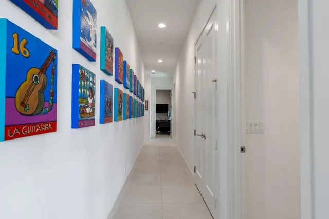 a bedroom with two beds and painting on the wall