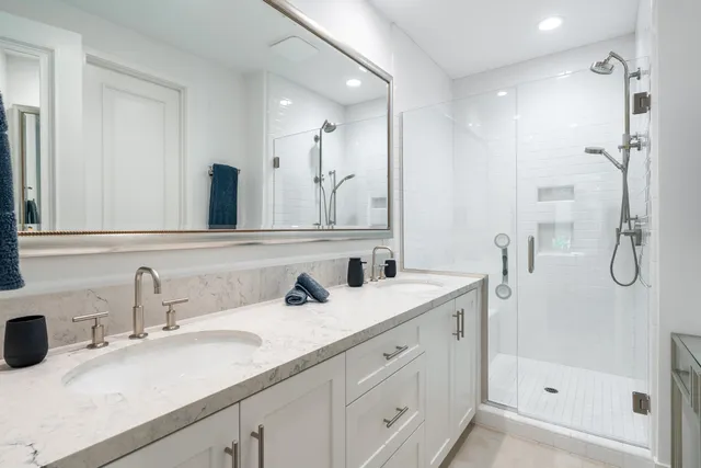 a bathroom with a shower sink and mirror