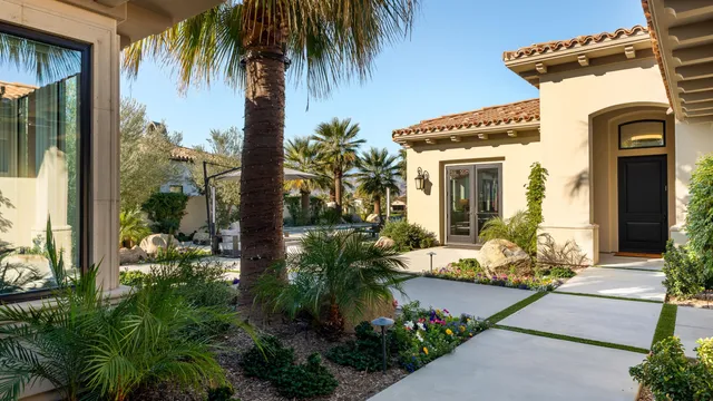 a front view of a house with a garden