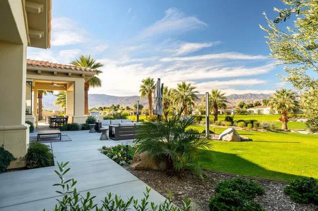 a view of a house with pool and chairs