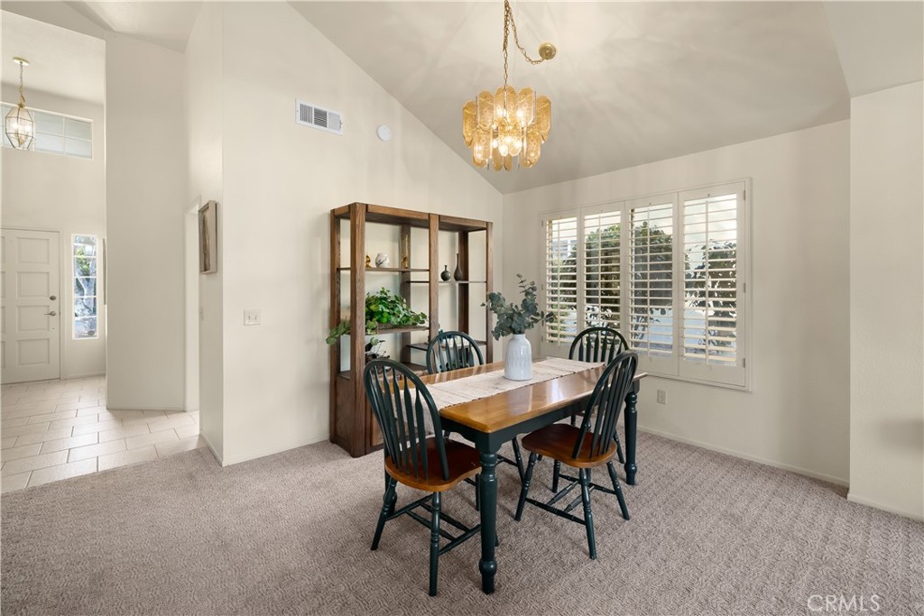 634 Riviera Circle Nipomo, CA 93444 - Photo 13 of 40 a view of a dining room with furniture a chandelier and wooden floor