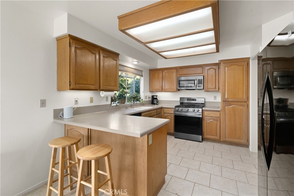 634 Riviera Circle Nipomo, CA 93444 - Photo 18 of 40 a kitchen with a sink cabinets and refrigerator