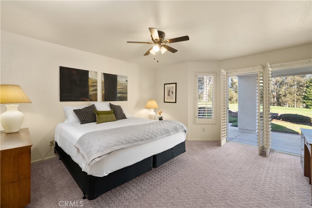 634 Riviera Circle Nipomo, CA 93444 - Photo 21 of 40 a spacious bedroom with a bed and large mirror