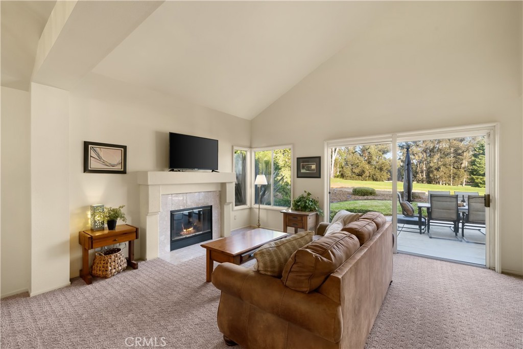 634 Riviera Circle Nipomo, CA 93444 - Photo 5 of 40 a living room with furniture a fireplace and a flat screen tv