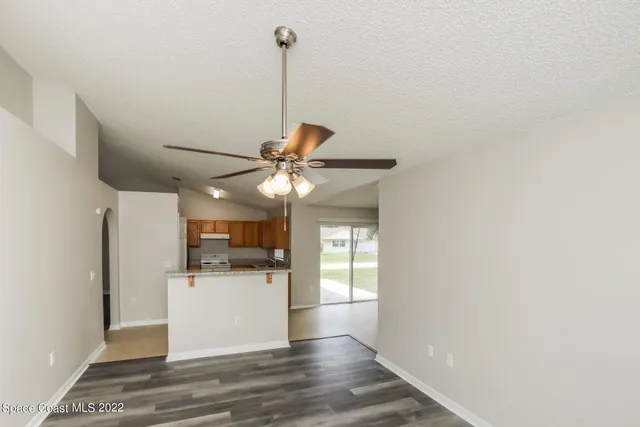 a view of a kitchen with a refrigerator and a ceiling fan