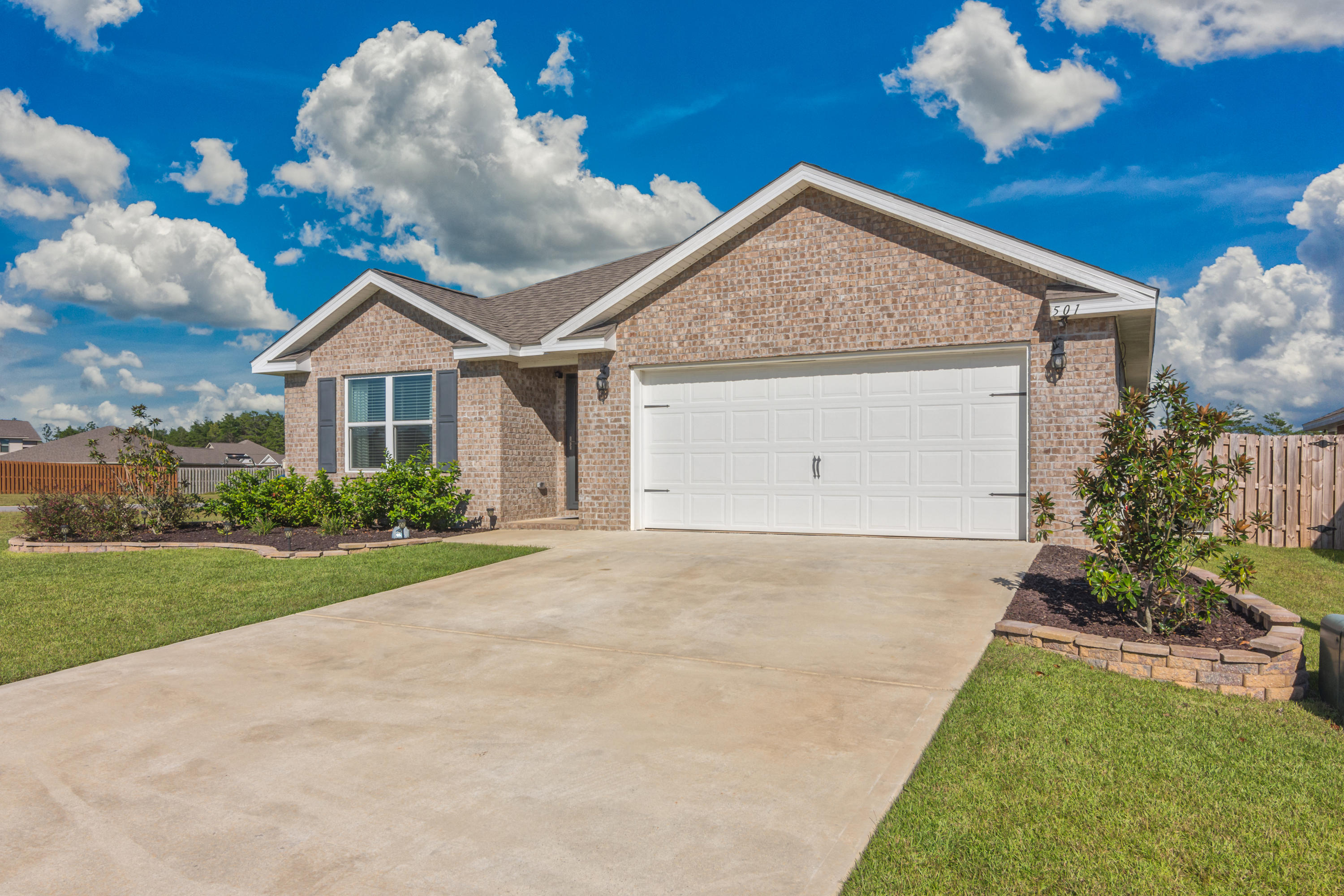 501 Merganser Way Crestview, FL 32539 - Photo 2 of 34 a view of a house with a yard and garden