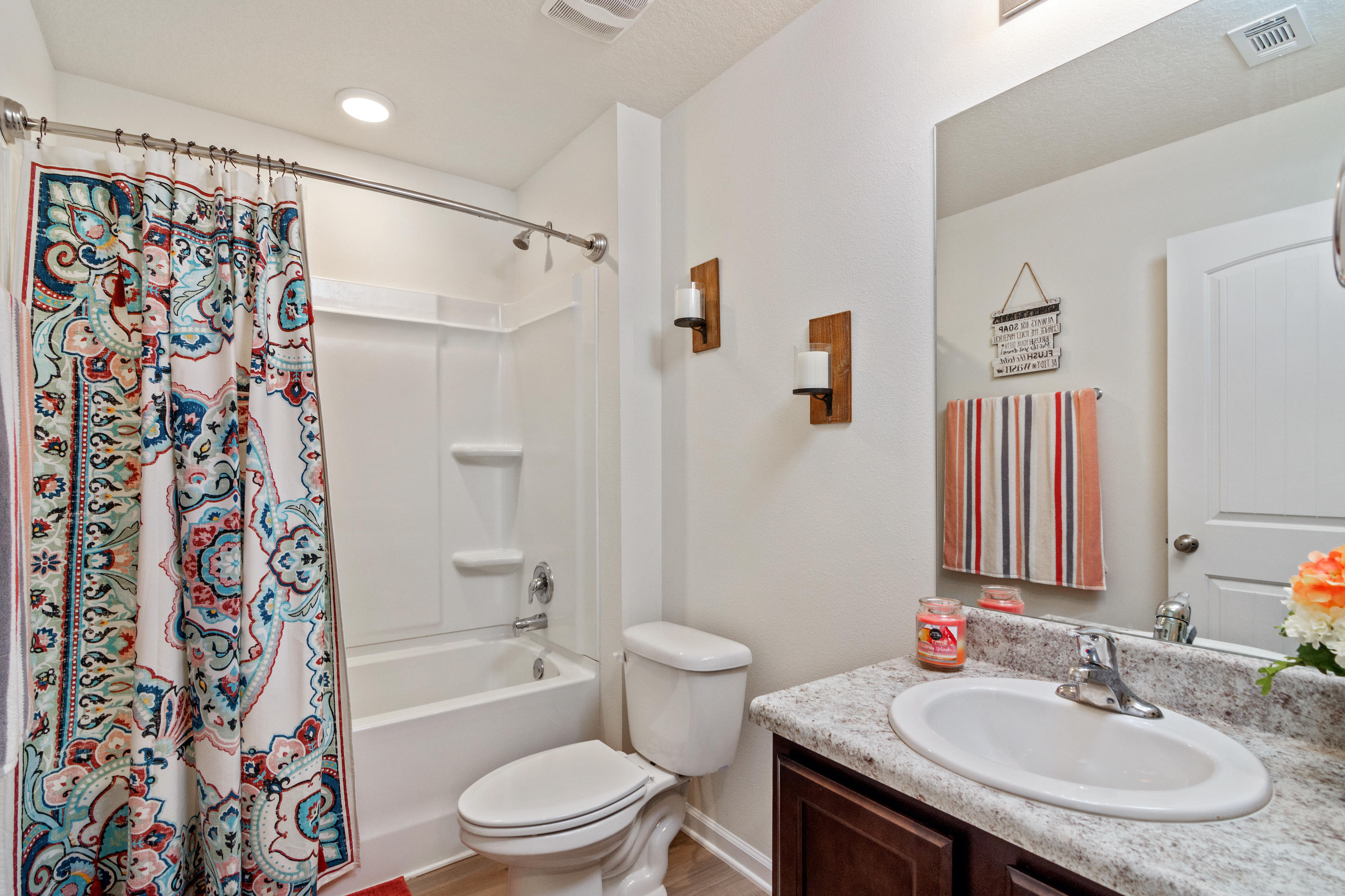 501 Merganser Way Crestview, FL 32539 - Photo 12 of 34 a bathroom with a sink toilet a shower and a mirror