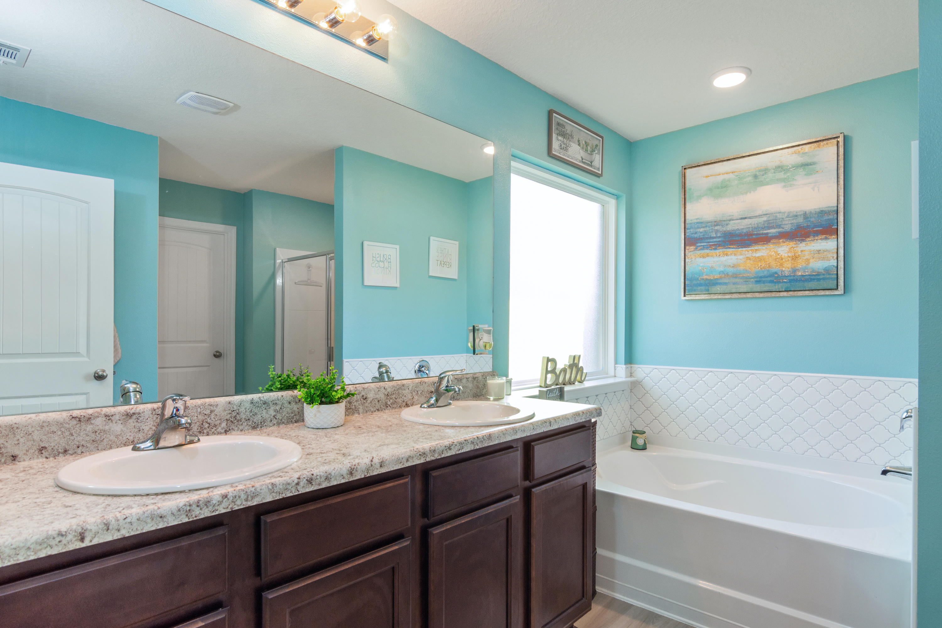 501 Merganser Way Crestview, FL 32539 - Photo 20 of 34 a bathroom with a tub double sink window and two