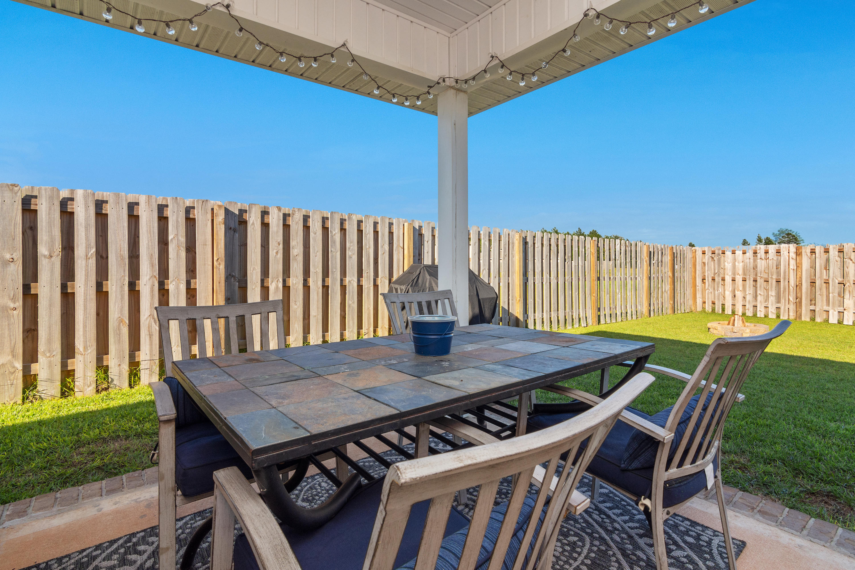501 Merganser Way Crestview, FL 32539 - Photo 24 of 34 a view of a patio with table and chairs with wooden fence