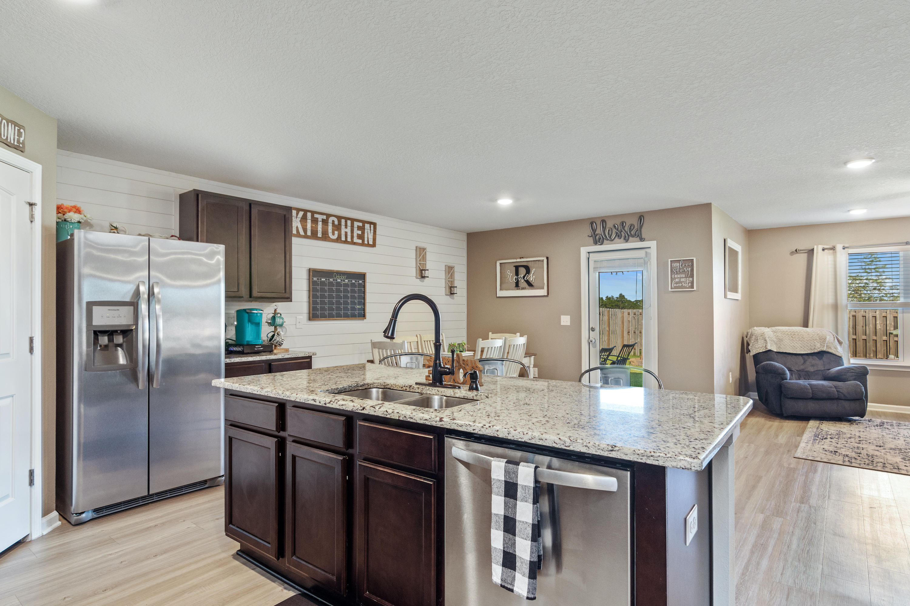 501 Merganser Way Crestview, FL 32539 - Photo 5 of 34 a kitchen with stainless steel appliances granite countertop a sink a stove and refrigerator
